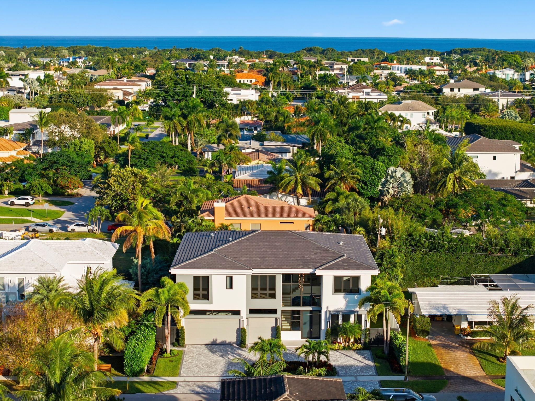 1050 Northeast 3rd Avenue Boca Raton, FL 33432 - Photo 25 of 63 an aerial view of a house with a garden and lake view