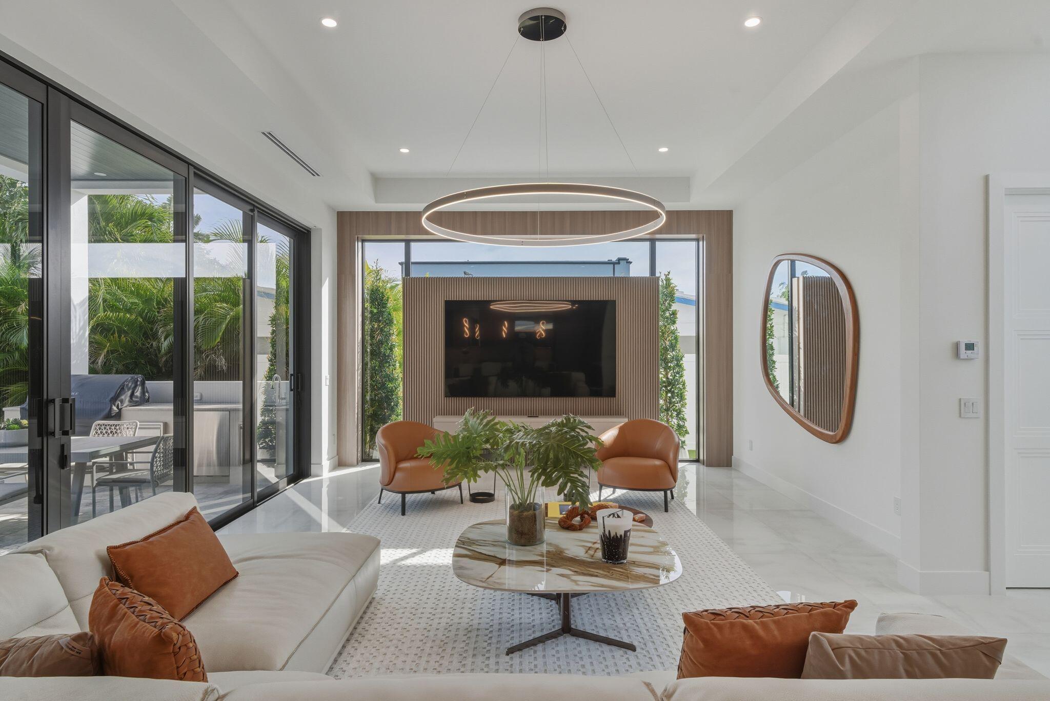 1050 Northeast 3rd Avenue Boca Raton, FL 33432 - Photo 27 of 63 a living room with furniture a fireplace and a large window