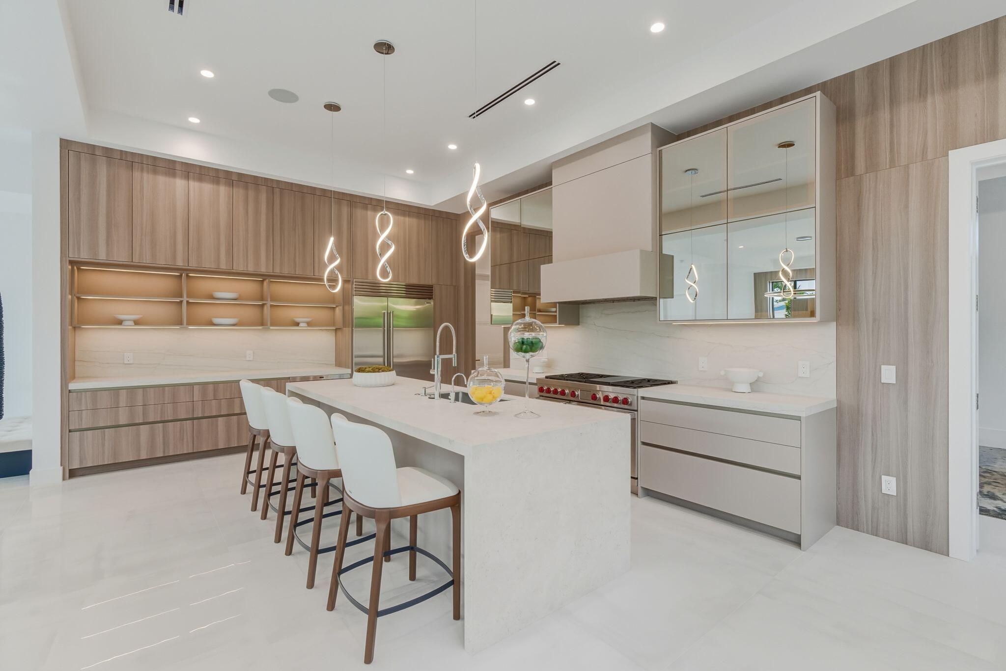 1050 Northeast 3rd Avenue Boca Raton, FL 33432 - Photo 34 of 63 a kitchen with stainless steel appliances granite countertop a stove a sink and a refrigerator