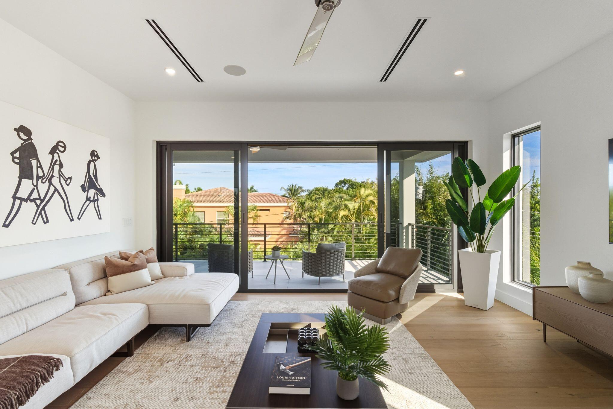 1050 Northeast 3rd Avenue Boca Raton, FL 33432 - Photo 57 of 63 a living room with furniture potted plant floor to ceiling window and a large window