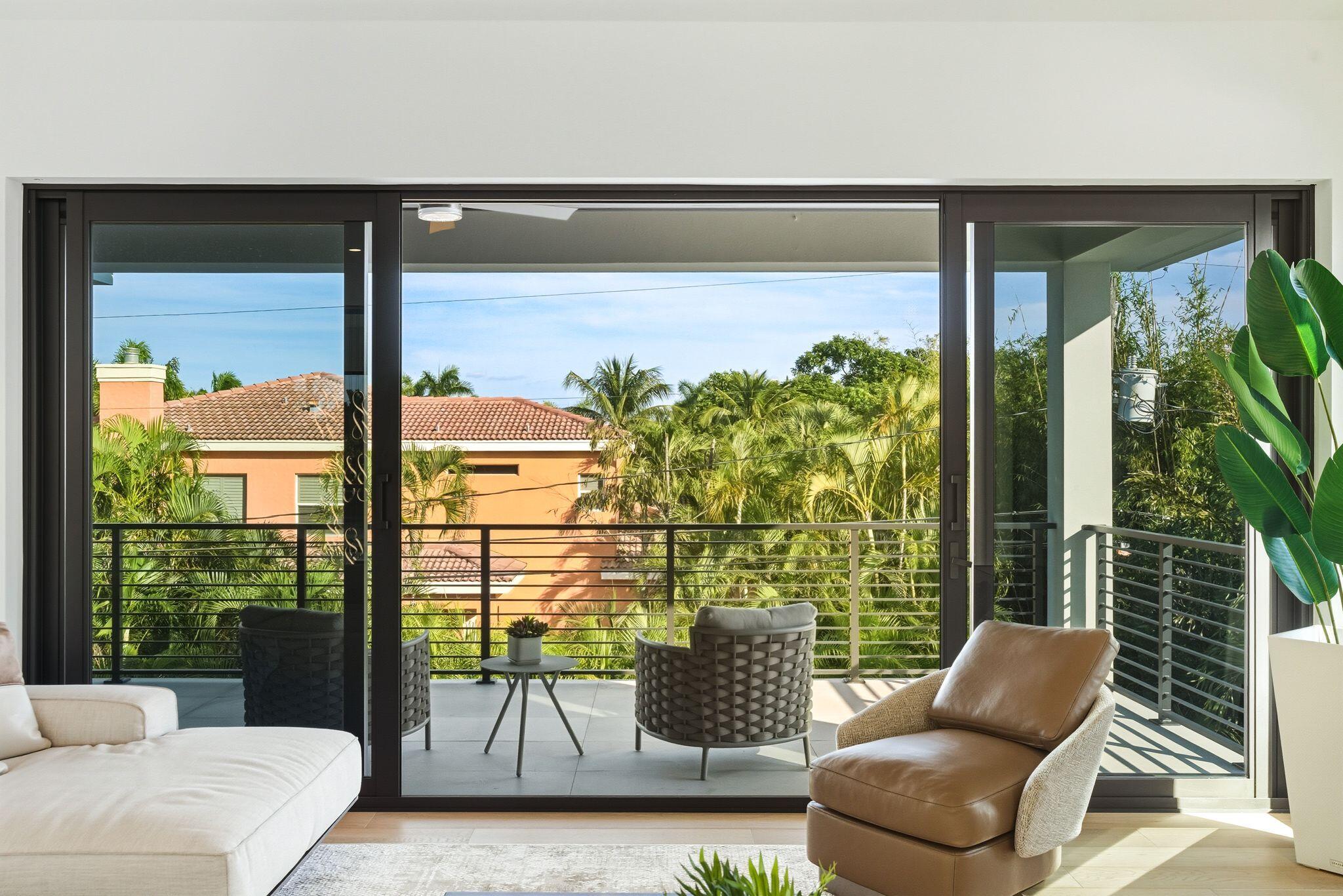 1050 Northeast 3rd Avenue Boca Raton, FL 33432 - Photo 58 of 63 a living room with couch and a potted plant
