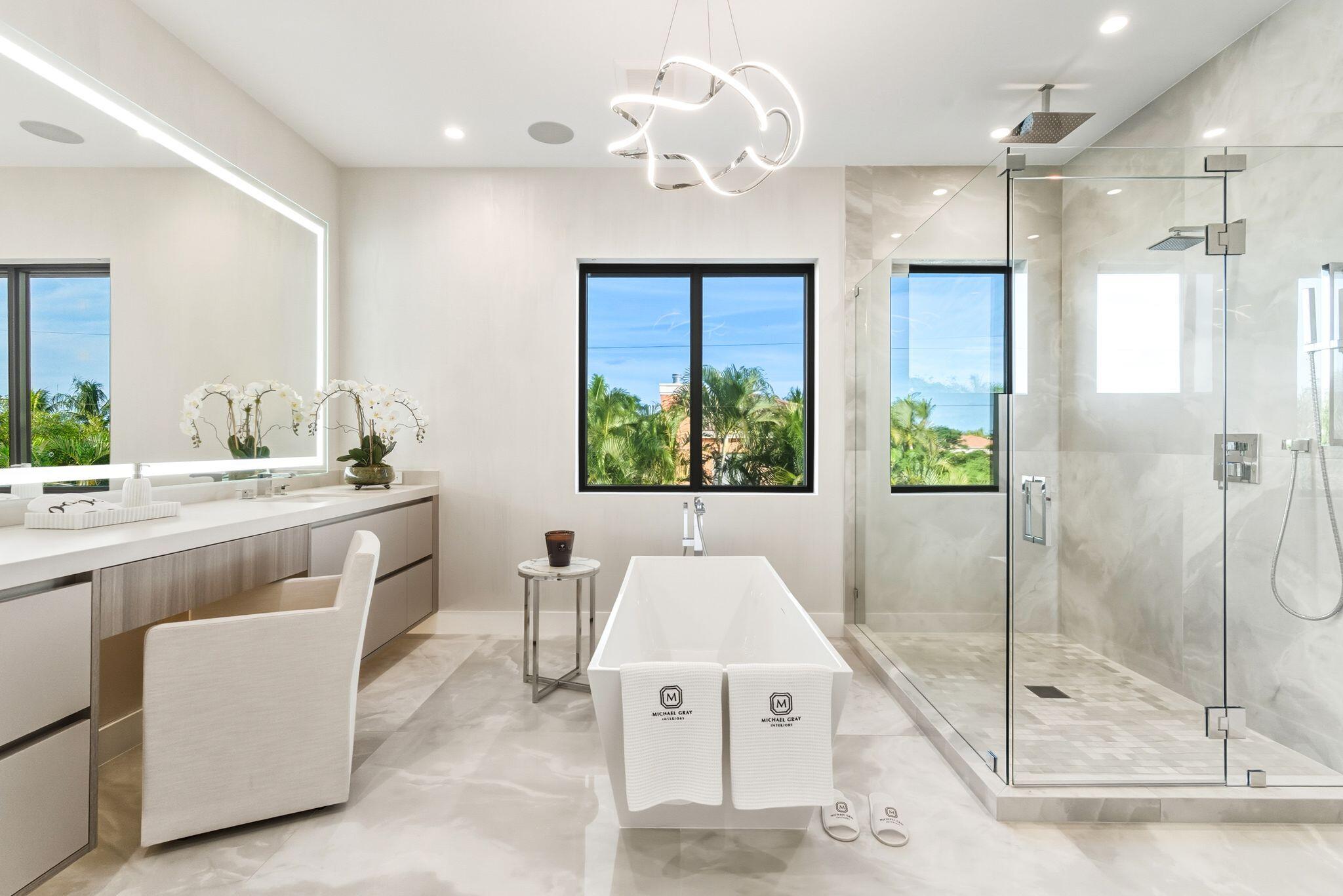 1050 Northeast 3rd Avenue Boca Raton, FL 33432 - Photo 59 of 63 a spacious bathroom with a granite countertop sink a large mirror and shower