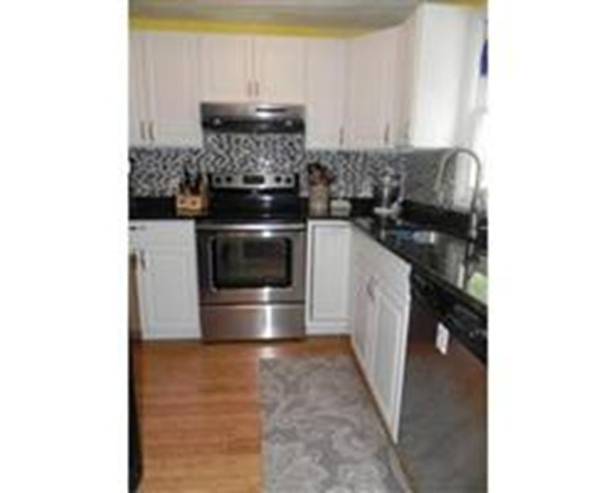 1 Meadowbrook Road, Unit 7 Grafton, MA 01519 - Photo 2 of 9 a kitchen with a stove and a refrigerator