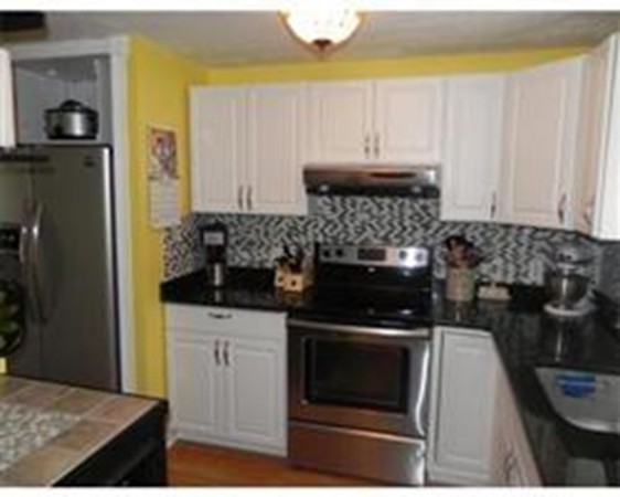1 Meadowbrook Road, Unit 7 Grafton, MA 01519 - Photo 3 of 9 a kitchen with a stove and a refrigerator