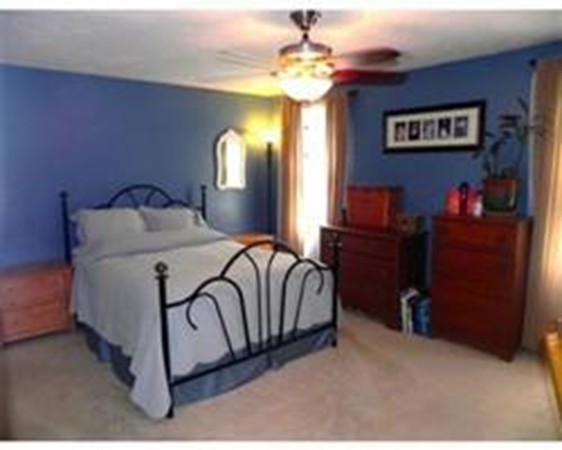 1 Meadowbrook Road, Unit 7 Grafton, MA 01519 - Photo 4 of 9 a bedroom with a bed and a chandelier