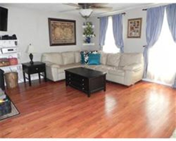 1 Meadowbrook Road, Unit 7 Grafton, MA 01519 - Photo 7 of 9 a living room with furniture and a large window