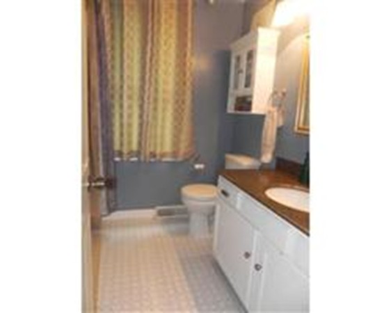 1 Meadowbrook Road, Unit 7 Grafton, MA 01519 - Photo 8 of 9 a spacious bathroom with a granite countertop sink a toilet and a mirror