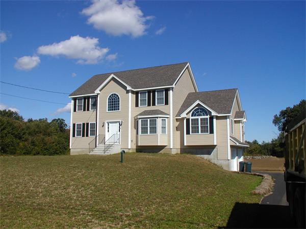 143 Lowell Road Salem, NH 03079 - Photo 1 of 9 a front view of a house with a garden