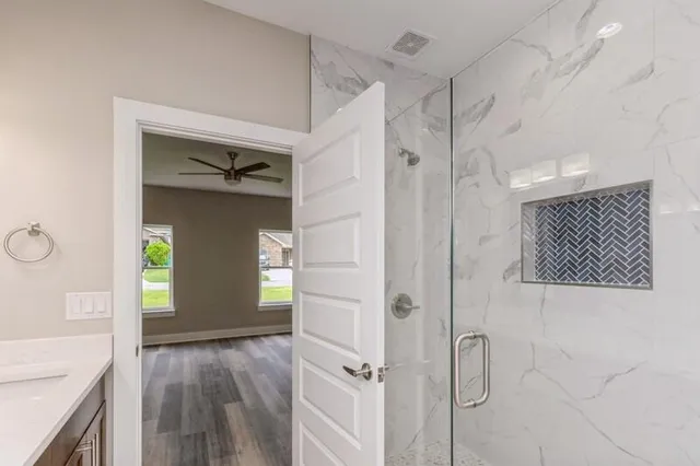 a view of a hallway view with wooden floor and staircase