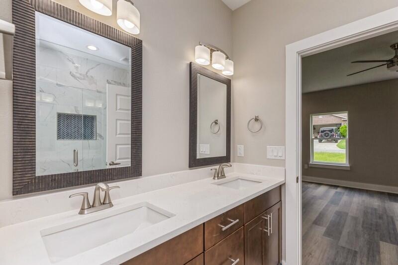 4540 Hermosa Road Crestview, FL 32539 - Photo 15 of 35 a bathroom with double vanity sinks and a mirror