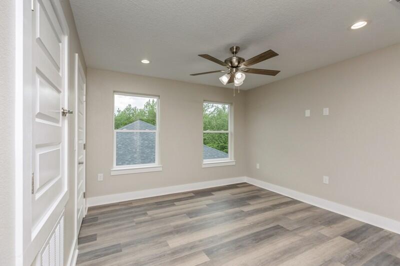 4540 Hermosa Road Crestview, FL 32539 - Photo 17 of 35 an empty room with wooden floor and windows