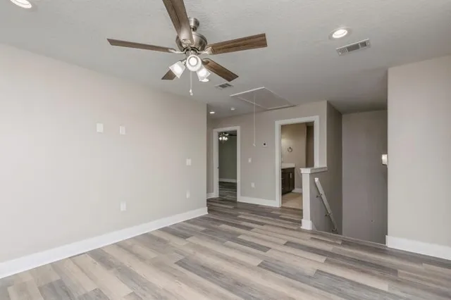 wooden floor in an empty room with a mirror