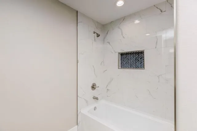 a bathroom with a bathtub and a shower