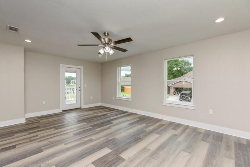 4540 Hermosa Road Crestview, FL 32539 - Photo 23 of 35 a view of an empty room with a window and wooden floor