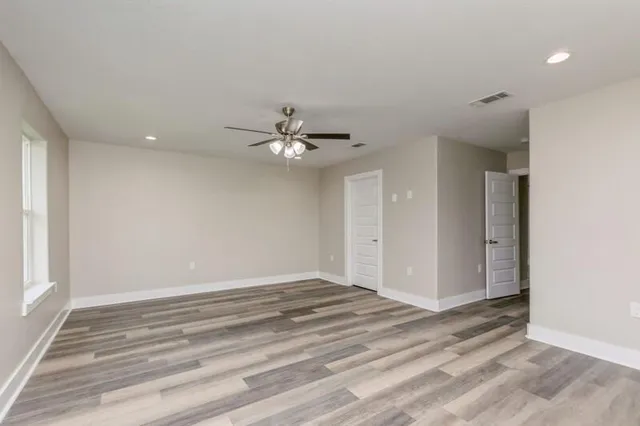 a view of a livingroom with a ceiling fan and window