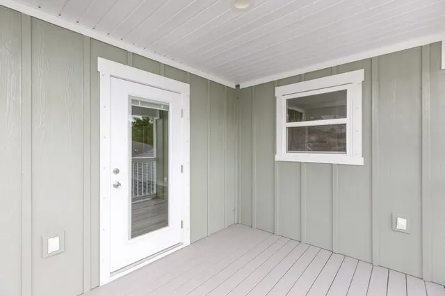 a view of a hallway with wooden floor and closet