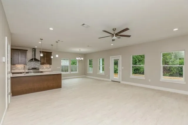 a large kitchen with a large window and a sink