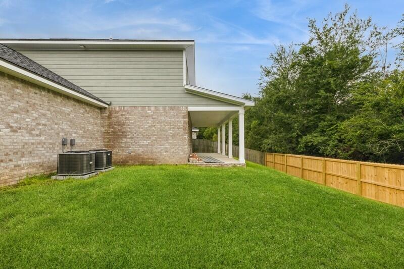 4540 Hermosa Road Crestview, FL 32539 - Photo 35 of 35 a view of a backyard with table and chairs and wooden fence