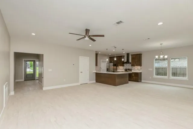 a view of a kitchen with a sink and window
