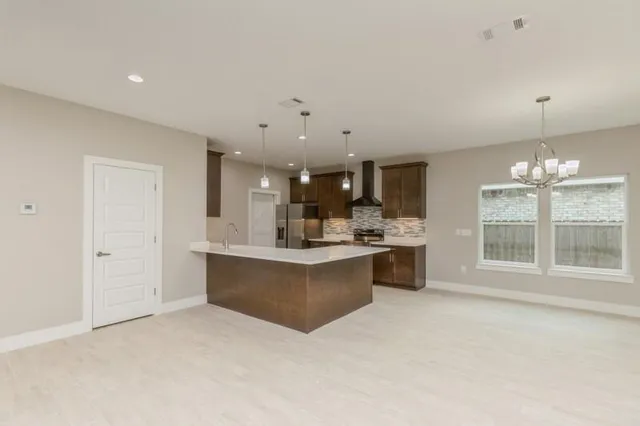 a large white kitchen with a large window