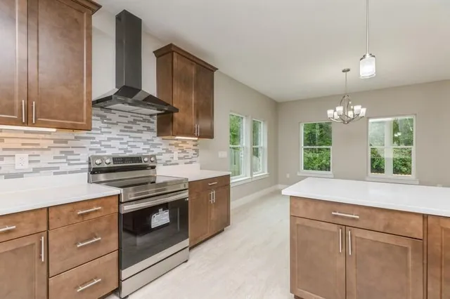 a kitchen with stainless steel appliances granite countertop a sink stove and cabinets