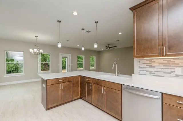 a kitchen with a sink and large window