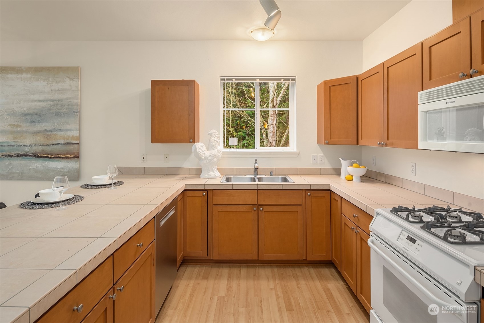17432 Bothell Way Northeast, Unit B206 Bothell, WA 98011 - Photo 14 of 28 a kitchen with a sink stove and cabinets