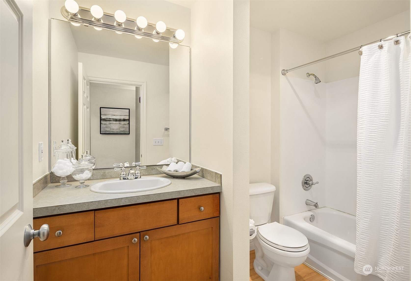 17432 Bothell Way Northeast, Unit B206 Bothell, WA 98011 - Photo 21 of 28 a bathroom with a granite countertop sink toilet a large mirror a shower and a bathtub