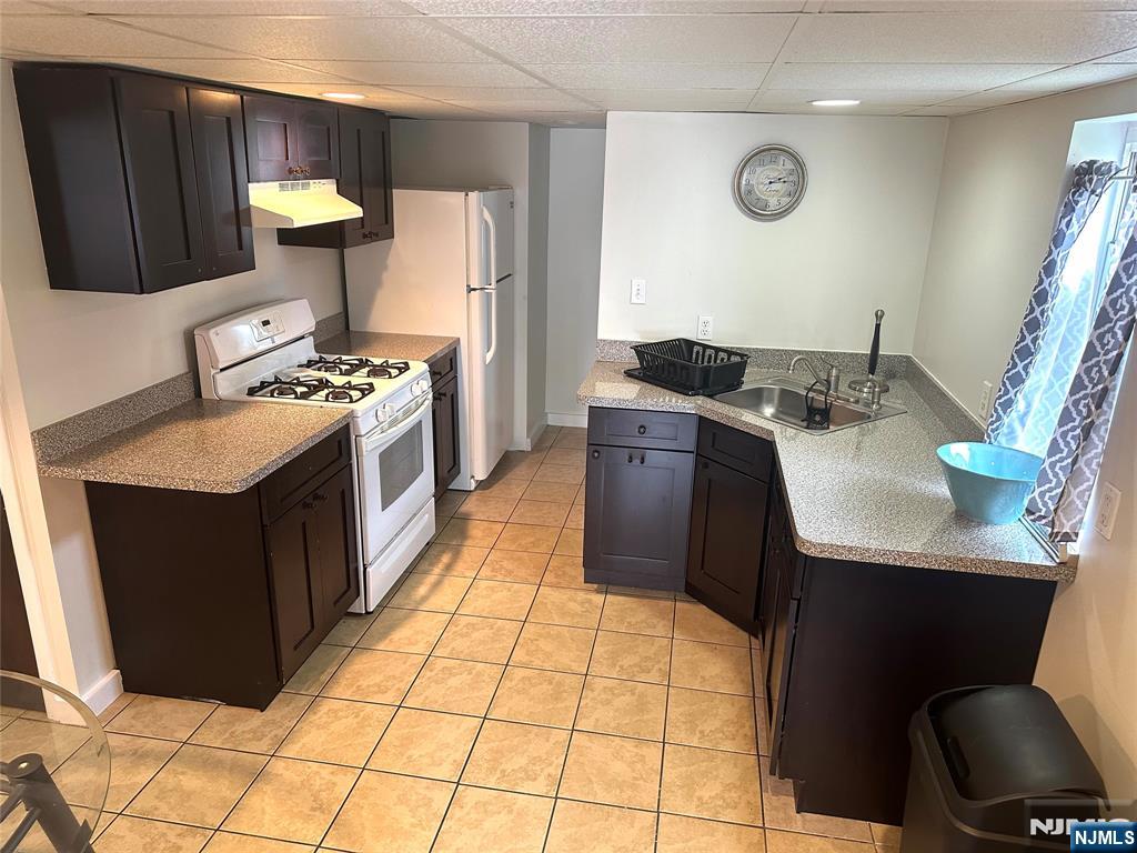 a kitchen with a sink stove and refrigerator
