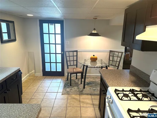 a view of a dining room with furniture and a window