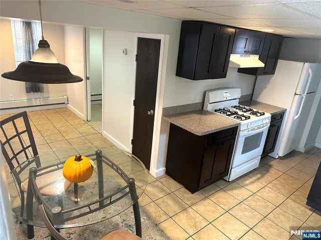a kitchen with stainless steel appliances granite countertop a stove a washer and dryer