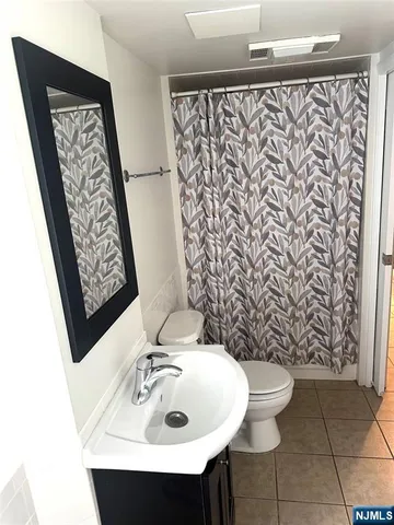 a bathroom with a sink and mirror with toilet