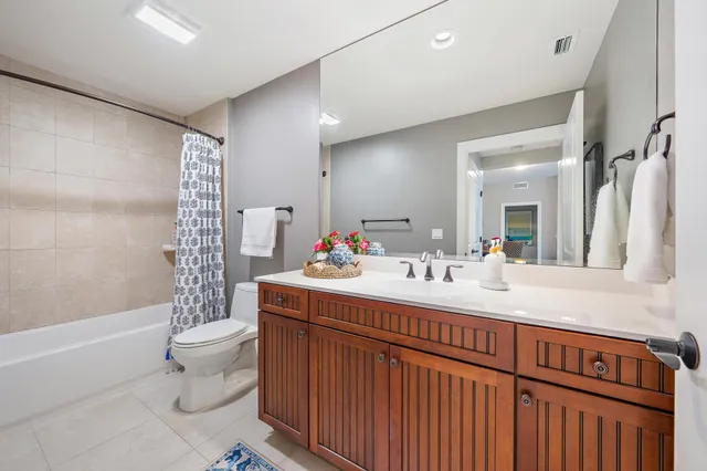 a bathroom with a double vanity sink toilet and shower