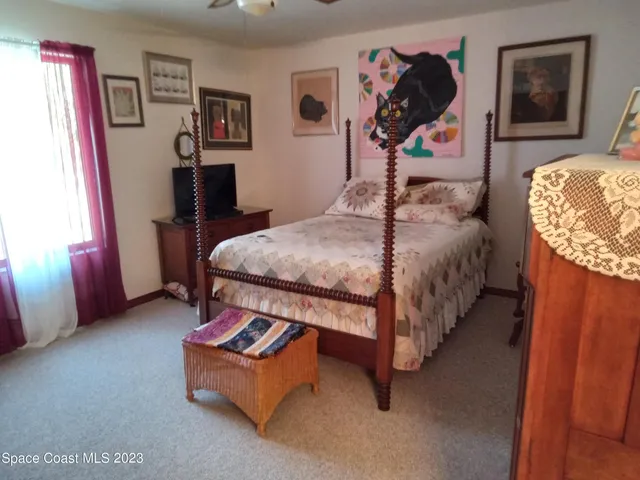 a bed room with a bed and dresser