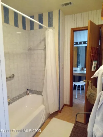 a bathroom with a tub and a shower