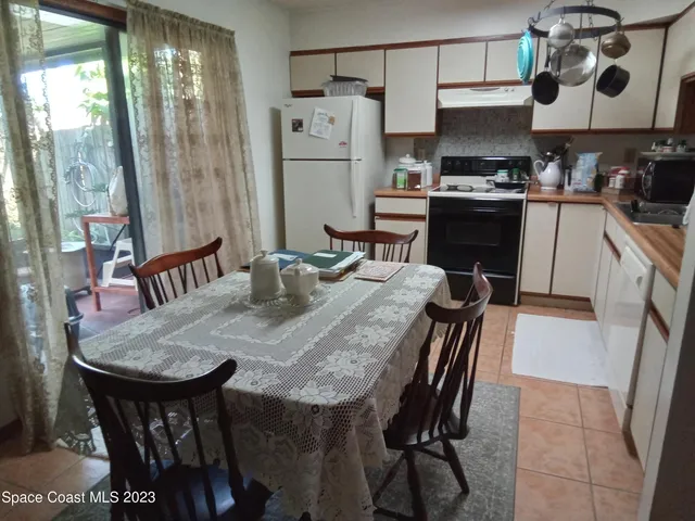 a kitchen with granite countertop a sink appliances a counter space and dining table