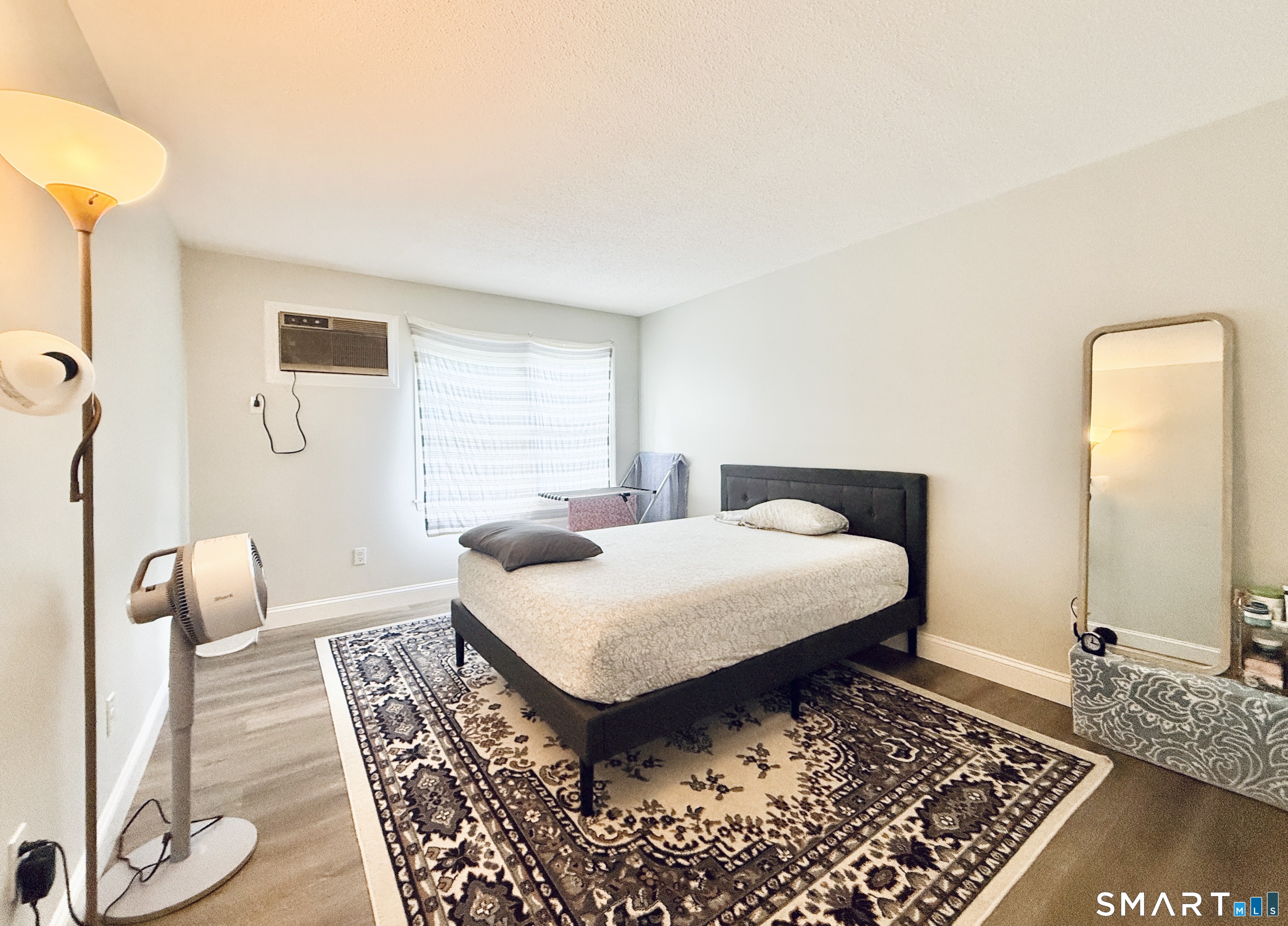 34 A Padanaram Road, Unit 127 Danbury, CT 06811 - Photo 8 of 13 a bedroom with a bed and wooden floor