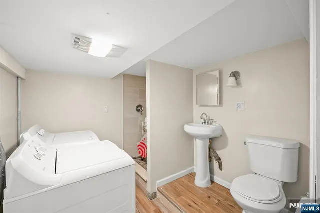 a bathroom with a sink toilet and a mirror