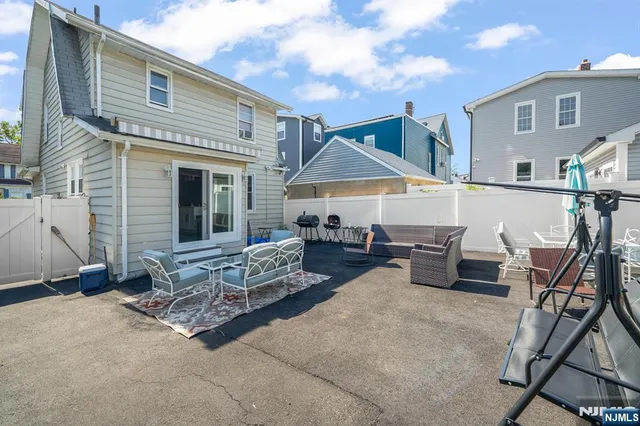 a view of a house with backyard sitting area and tub