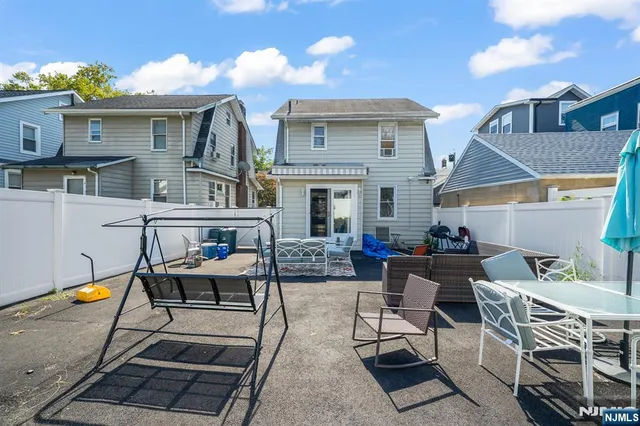 a view of a house with backyard water fountain and sitting area
