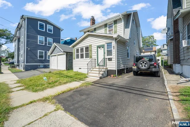 a front view of a house with a garden and pathway