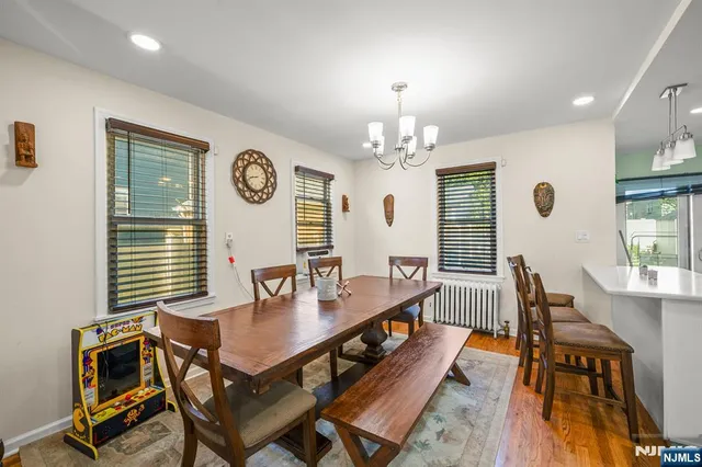 a view of a dining room with furniture and chandelier