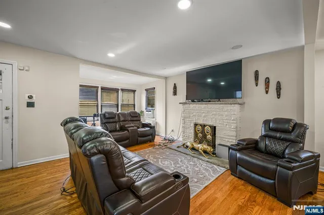 a living room with furniture a fireplace and a flat screen tv