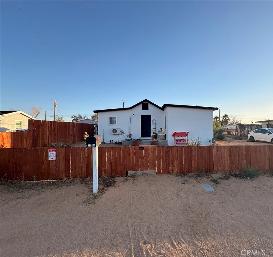a view of a house with wooden fence