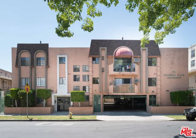 a front view of a house with a garden and plants