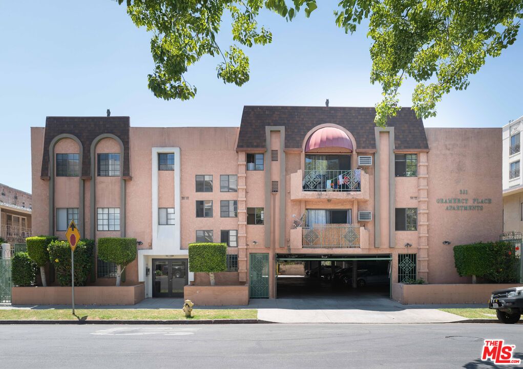 a front view of a house with a garden and plants