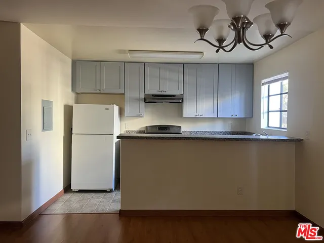 a kitchen with a refrigerator and cabinets