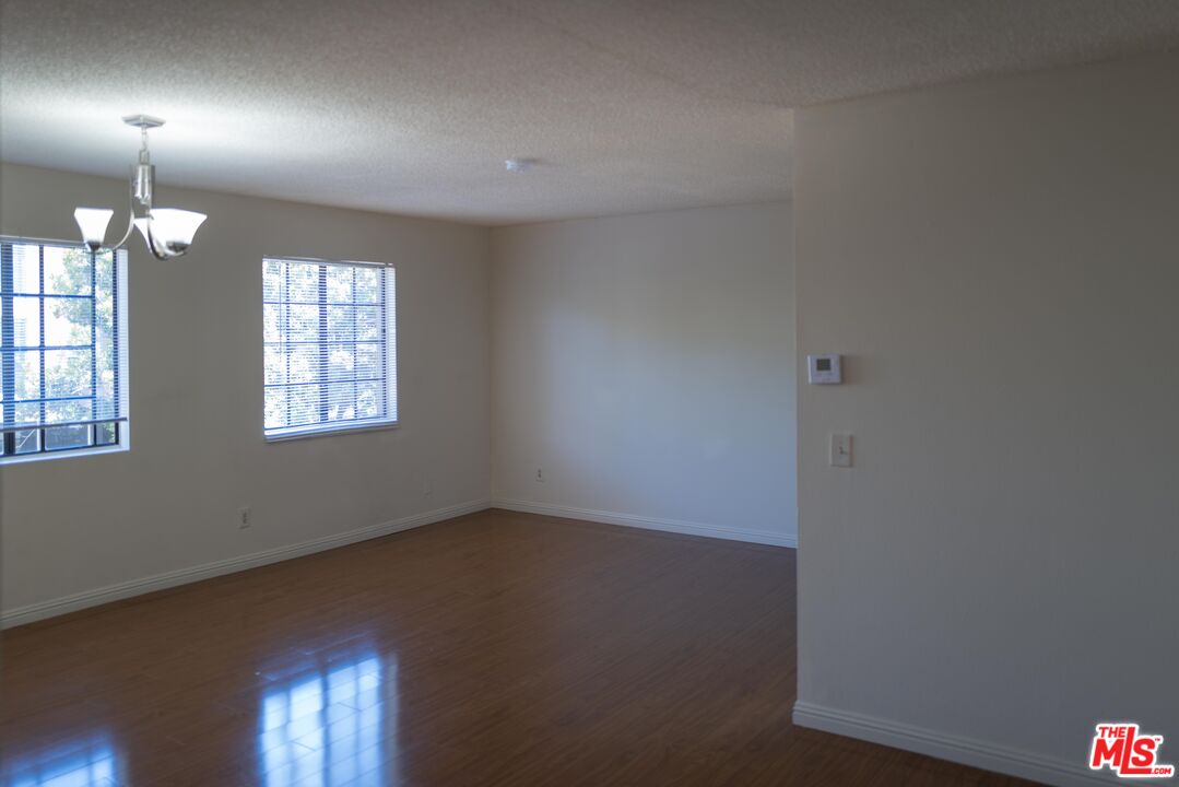 331 South Gramercy Place, Unit 101 Los Angeles, CA 90020 - Photo 4 of 7 an empty room with windows and fan