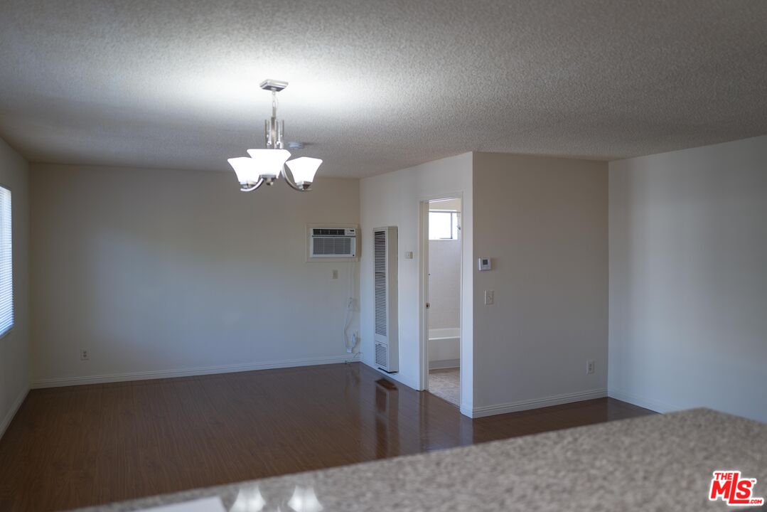 331 South Gramercy Place, Unit 101 Los Angeles, CA 90020 - Photo 5 of 7 an empty room with wooden floor windows and closet