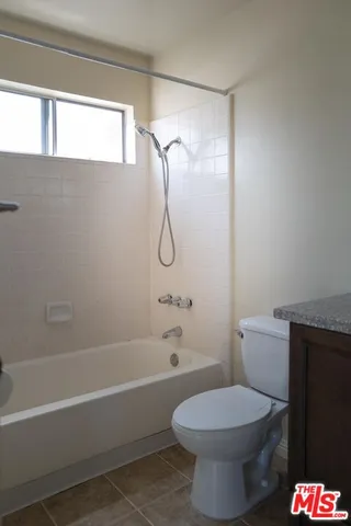 a bathroom with a toilet and a bathtub